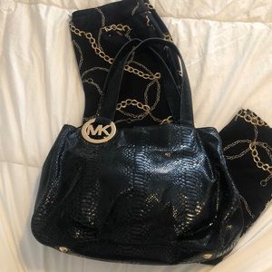 Black snake skin bag with golden logo